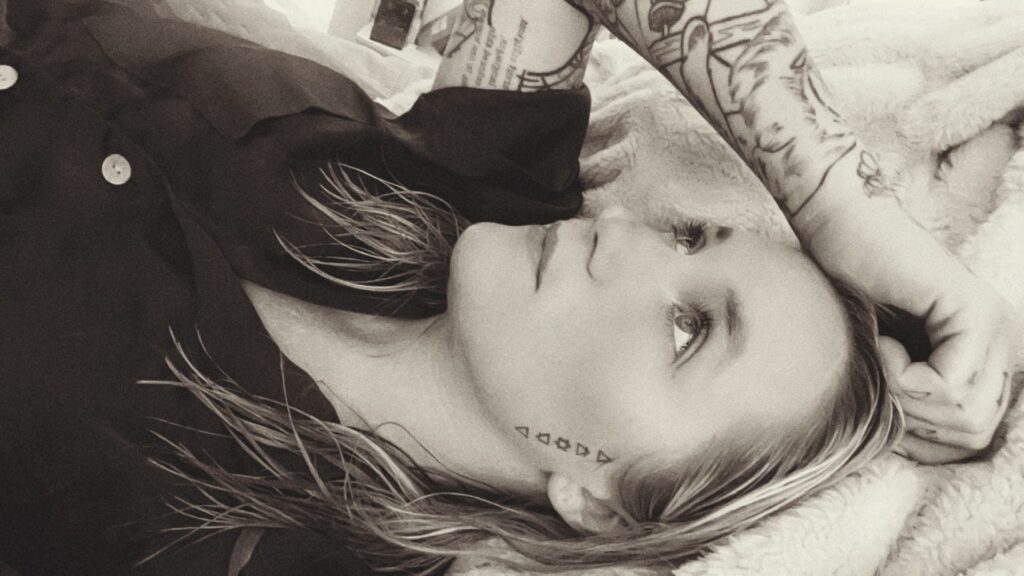 Nikyla lying down, photographed in black and white.