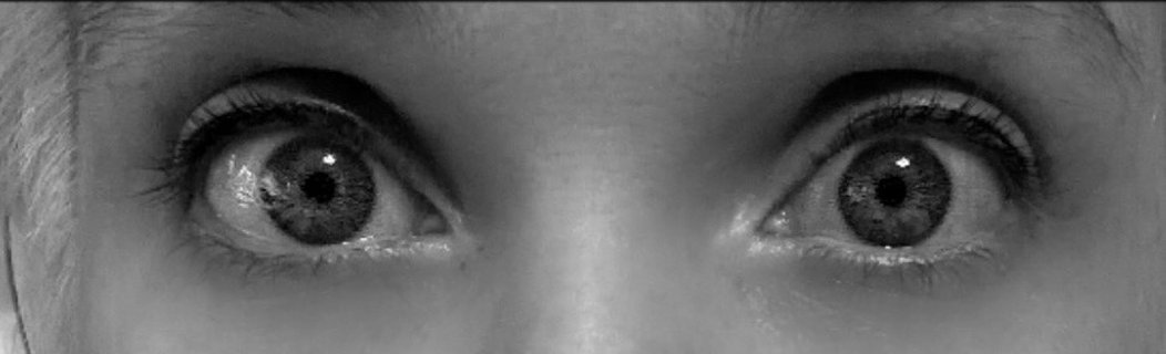 Black-and-white close-up of Nikyla's eyes, wide open.