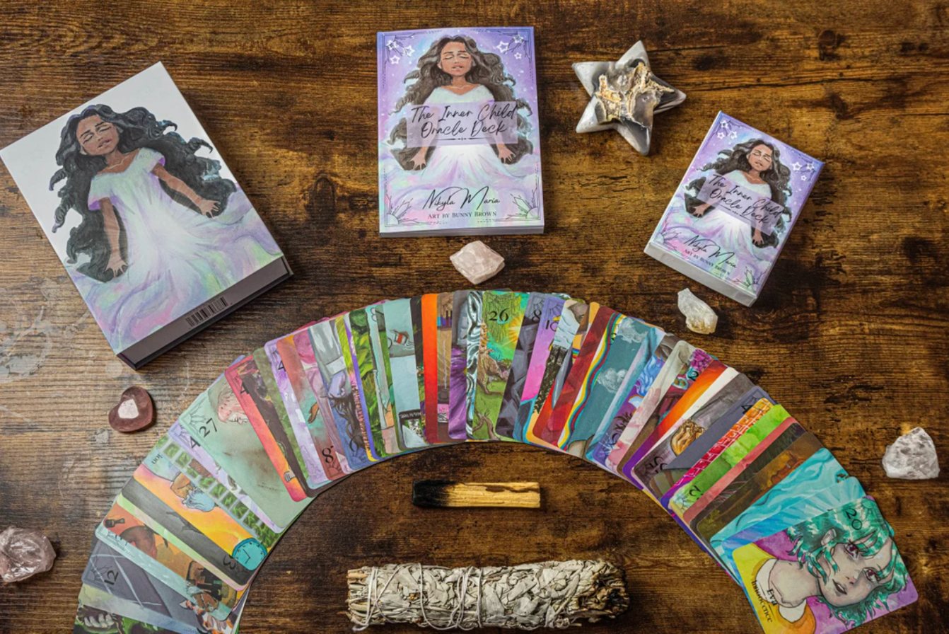 The Inner Child Oracle Deck spread on a wooden table.